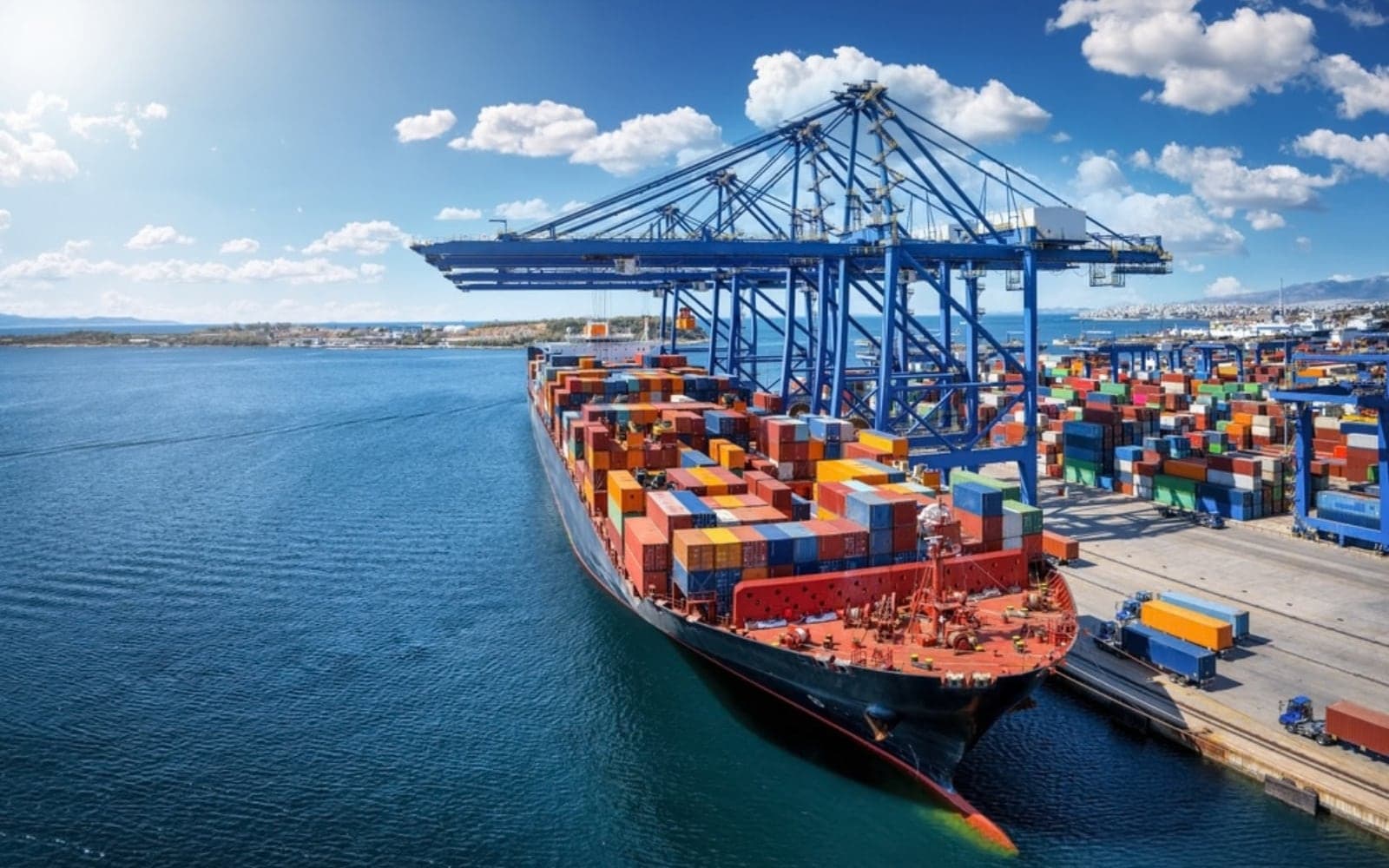 Container ship berthed at a port under ship-to-shore cranes