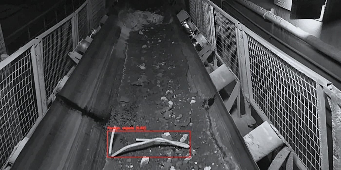 AI conveyor monitoring camera view with a foreign object detected on the belt